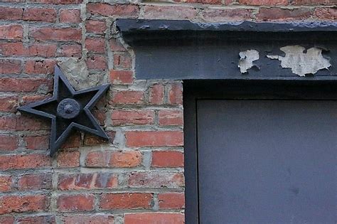 significance of metal stars on houses|cast iron stars on buildings.